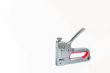 A construction stapler. A tool for repair and construction. A working tool. The construction...