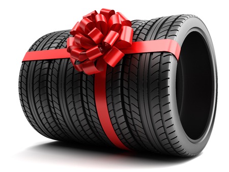Gift set of tires wrapped ribbon and bow isolatedの写真素材
