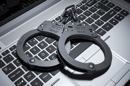 Handcuffs on laptop keyboard. Copyright concept 3dの写真素材