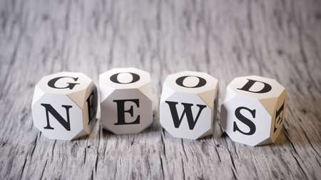 Good news cubes on wood plane 3d renderの写真素材