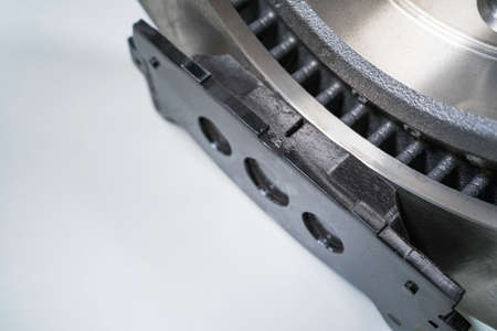 brake pads and auto parts on a white table