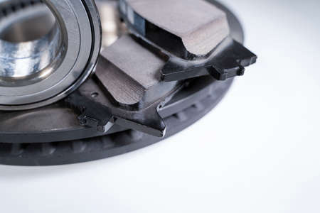 brake pads and auto parts on a white table