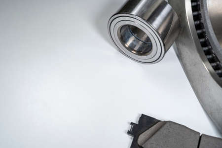 brake pads and auto parts on a white table