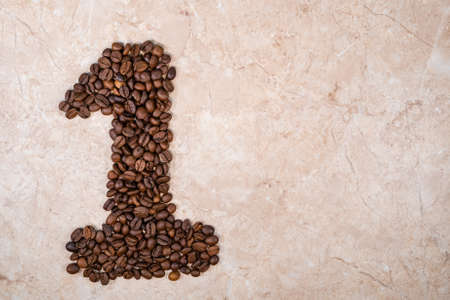 brown roasted natural coffee beans in the form of number oneの写真素材