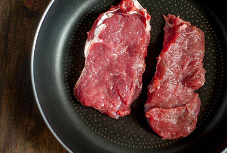 fresh raw meat on old wooden tableの写真素材