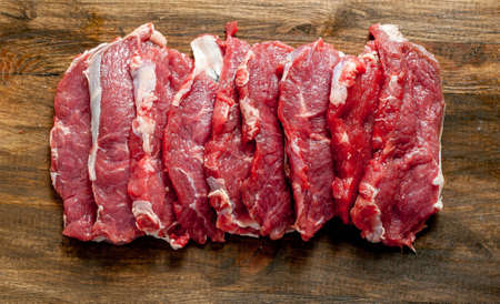 fresh raw meat on old wooden tableの写真素材