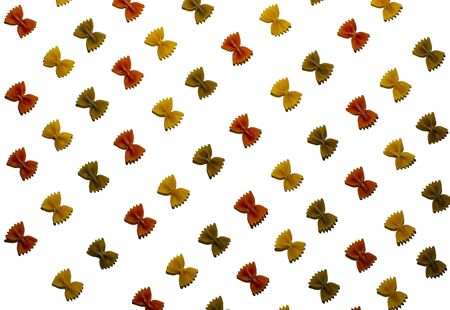 Colored pasta bows on a white background close-upの写真素材