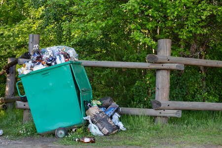 Russia, St. Petersburg, June 20, 2020: large green garbage container overflowing with garbage.のeditorial素材