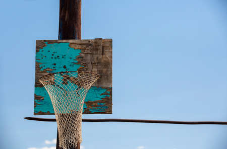 Old homemade wooden basketball hoop against the sky. Horizontal bar from a steel bar.の写真素材