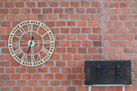 Clock and chest on brick wall backgroundの写真素材