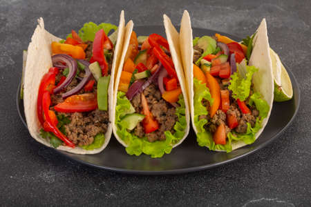 Mexican tacos with minced meat and vegetables close-upの写真素材