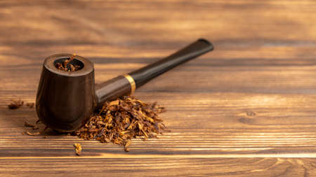 Smoking pipe and tobacco on wooden backgroundの写真素材