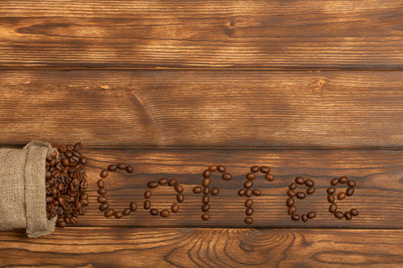 The inscription coffee from beans on a wooden background. Copy space. Flat layの写真素材