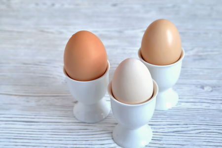 Eggs in stands on a light background