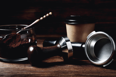 temper portofilter wooden coffee spoon paper cup on natural wooden brown background close-up copy spaceの写真素材