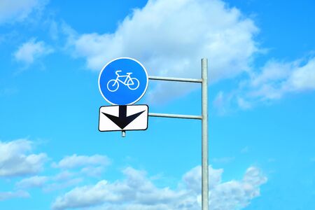 Road signs bike path pointer and arrow on the background of sky and forest for information use close-upの写真素材