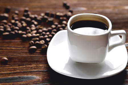 white coffee cup, morning side light coffee beans, natural wooden background close-upの写真素材