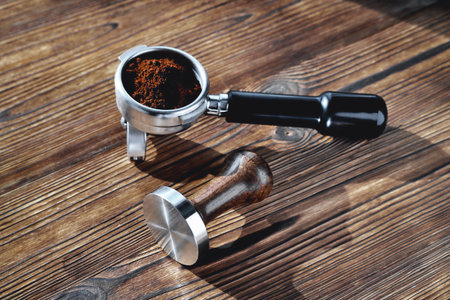 coffee horn and tamper on wooden background close-up, selective focusの写真素材