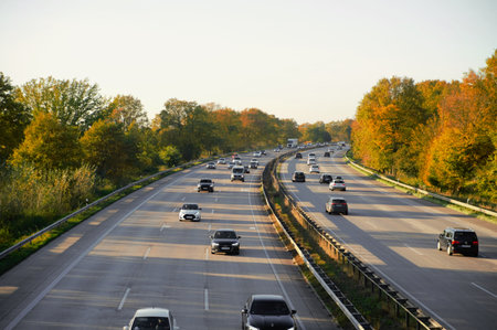 view of autumn Autobahn with cars in side sunlight close-up selective focus