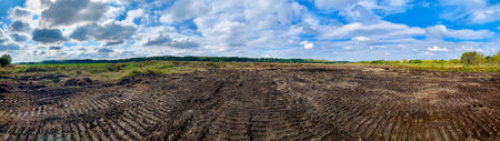 prepared construction site with traces of bulldozer leveling against blue sunny sky close-up with...