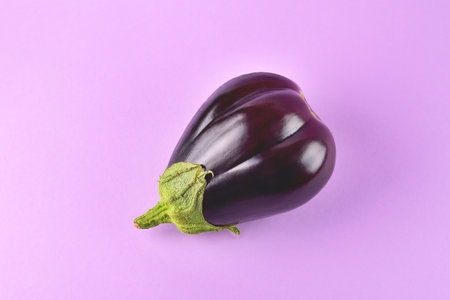 Eggplant on a purple background, fresh juicy vegetable on a colored background, selective focusの写真素材