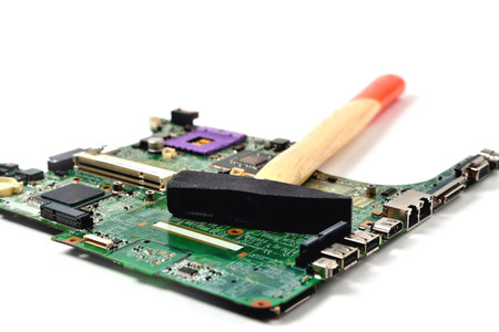 hammer lies on old chip from laptop, white background, isolate