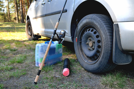 fishing accessories near a car sunny day, sunny glare, preparation for fishing close-upの写真素材