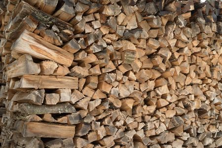 firewood stacked in the yard.them drown in the winter the stove in the huts.の写真素材