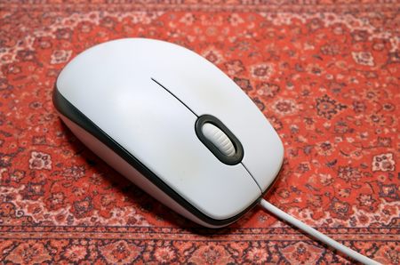 the computer mouse is on a red Mat.の写真素材