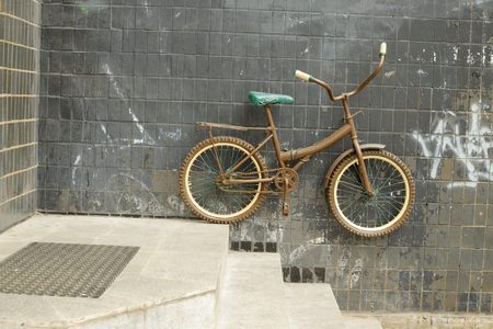 The bike hangs on the wall near the entrance to the house.の写真素材