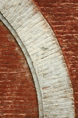 walls of red brick.architectural element of white color in the form of an arc.の写真素材