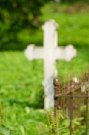 Christian cross on a green background in the Church yard.の写真素材
