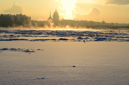 The sun rises over the city,when the street is winter..の写真素材