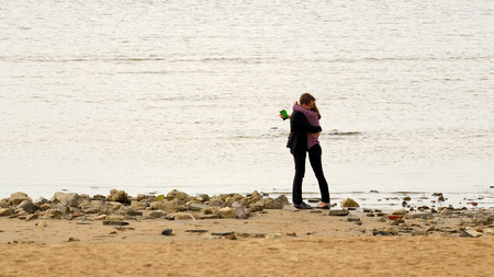 29.05.2016.Russia.Saint-Petersburg.Young men standing on the shore of the sea Bayのeditorial素材