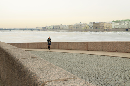 26.03.2016.Russia.Saint-Petersburg.The road along the river promenade is lined with fine stone blocks.のeditorial素材