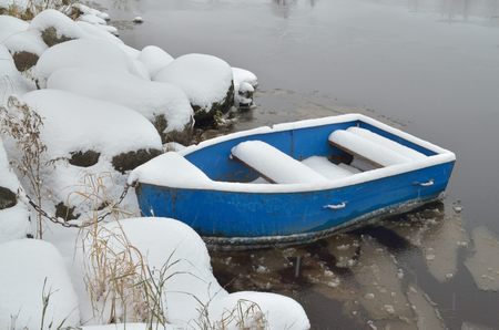 In the winter when the river freezes,the boat is not being used for transportation.の写真素材