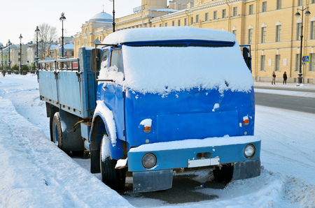 The truck, parked at the curb covered with snow.の写真素材