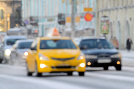On a city street among transport seen moving taxi.