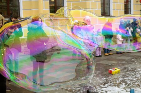 29.01.2017.Russia.Saint-Petersburg.Man makes soap bubbles.The children are very happy.