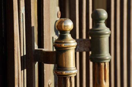 On the red doors of the building have locks with beautiful handles.