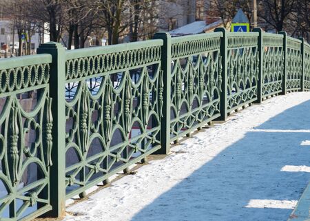 The iron railing of the bridge painted green.の写真素材