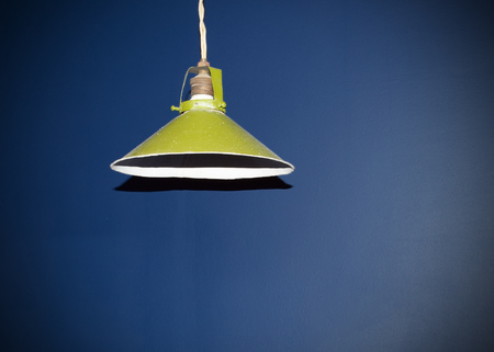 Round Green Lampshade hanging on the ceiling in the room.の写真素材