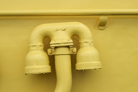 Iron pipe aboard ship.To it is connected a fire hose.の写真素材