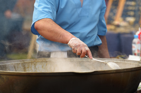 In a wide pot is preparing a large portion of barley porridge.の写真素材