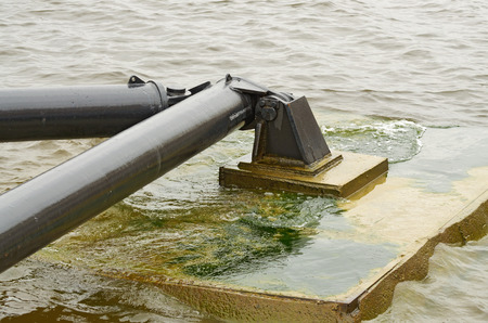 On the water is a helipad. It is secured to the shore using a metal mount .