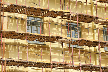 Construction scaffolding on the facade of the house.The restoration of the walls of the building.の写真素材