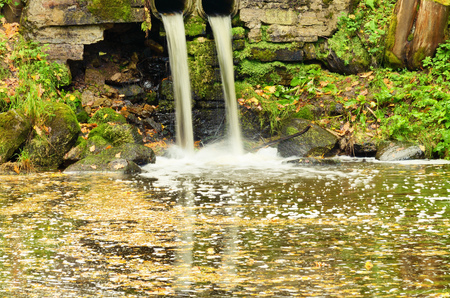 The water in the river falls from a height ,creating a spray.