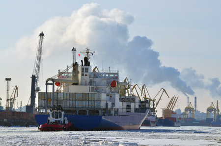 Ship being loaded at the port and now it sails home.