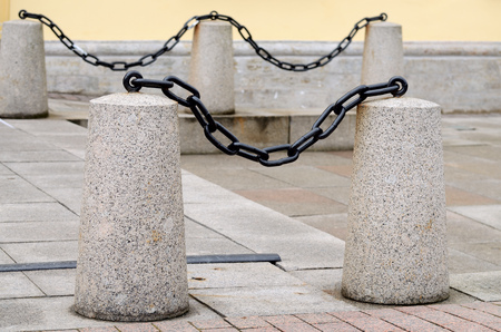 Granite posts with chains.The aesthetic embellishment on the street.