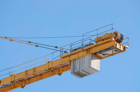 Tower cranes on the construction of houses .They lift heavy loads at the top.の写真素材